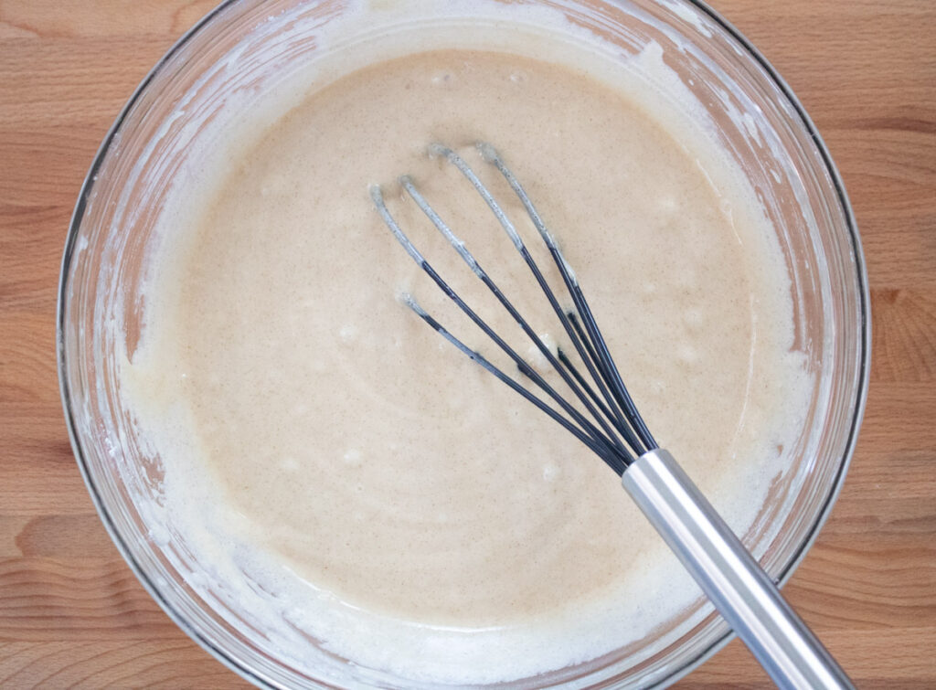 batter in glass bowl with whisk