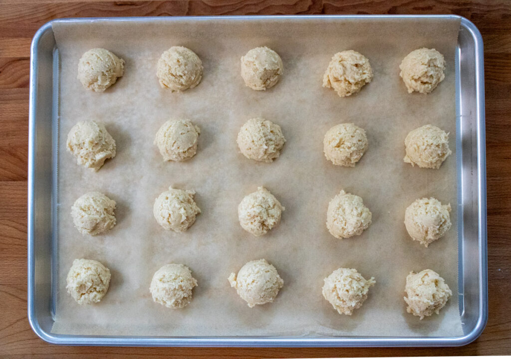 unbaked vegan cookie dough scoops on cookie sheet